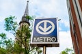 stm metro sign with church to its side