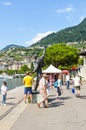 Montreux, Switzerland - July 26, 2019: People on the promenade by Geneva Lake around the statue of Freddie Mercury, lead singer of