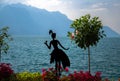 Montreux, Switzerland - September 14, 2017: Figure silhouette of girl woman near tree and flowers on promenade of the Lake Leman Royalty Free Stock Photo