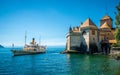 Montreux touristic steamboat on Lake Geneva and Chillon castle view with clear blue sky in Vaud Switzerland