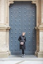 Montserrat, Spain - April 5, 2019: Young wonan poses in front of the Santa Maria de Montserrat Abbey, Catalonia, Spain.