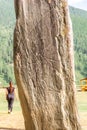 a monument of ancient activity - the Deer stone or Olenny stone Adyr-Kan, which is abandoned by a young curvy woman