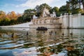 Monument with ancient statues and pond with floating ducks in Vienna.