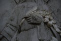 Monument and candles in the cemetery. All Saints Day in Poland. Stone sculpture. Stone flowers.