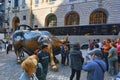 Monument of Charging Bull Financial on Broadway, near Wall Street in the New York with people and tourists. Royalty Free Stock Photo