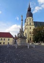 Monument and a church of saint Nicholas in centre of Trnava, Slovakia. Royalty Free Stock Photo