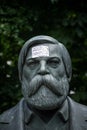 Monument of Engels in Berlin with the message: propaganda covers totalitarian structures