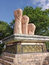 a monument with hands, three hands on a mountain of sand, Balikpapan, Indonesia.