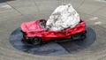 Monument of a huge stone on a crashed red car, Australia.