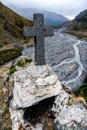 Monument with a large stone cross on top of a mountain overlooking Royalty Free Stock Photo