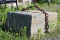 Large chained granite block in garden marking where the last crane stands, downtown Hallowell, Maine, summer, 2022