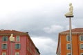 Monument of men up in the air on sky background