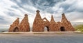 Monument near road, dedicated to ancient cave dwellings carved out of soft volcanic tuff rocks, that is the main attraction of Royalty Free Stock Photo