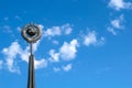 A monument of the Soviet era hammer and sickle on the background of blue sky Royalty Free Stock Photo