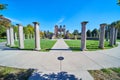 Monument of stone pillars leading to old ruins in park Royalty Free Stock Photo
