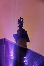 The monument to the angel of the city rises above the working light machine