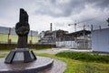 Monument to the Chernobyl liquidators with fourth reactor on the background