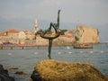 Monument to the dancer. Against the background of people resting by the sea. Budva, Montenegro