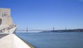 Monument to the Discoveries and red bridge, Lisbon, Portugal Royalty Free Stock Photo