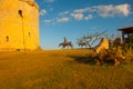 Monument to don Quixote and Sancho Panza at the tower of the fortress in the evening. Varadero. Cuba