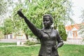 Monument to famous poetess Lesya Ukrainka in a blooming cherry garden in Kyiv