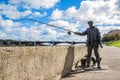 The monument to fisherman and the cat on the embankment of the river Volga in Tver, Russia. Picturesque clouds in the sky