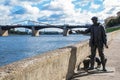 The monument to fisherman and the cat on the embankment of the river Volga in Tver, Russia. Picturesque clouds in the sky