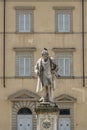 The monument to Giuseppe Mazzoni in the old town of Prato, Italy, with a pigeon on the head