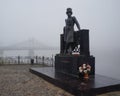 Monument to the great Russian poet Alexander Pushkin on the Volga river embankment in a thick morning fog