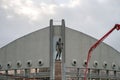 Monument to Ivan Yarygin, Olympic champion in freestyle wrestling, against the background of the Palace of Sports in Krasnoyarsk.