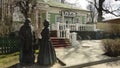 Monument to a merchant and his wife in front of a restaurant in the center of Dmitrov, Russia. Sunny spring view.