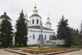 Monument to Semyon Ivanovich Dezhnev against the background of the Cathedral of the Assumption of the Blessed Virgin Mary in Velik