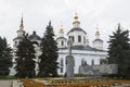 Monument to Semyon Ivanovich Dezhnev against the background of the Cathedral of the Assumption of the Blessed Virgin Mary