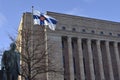 the monument to third president of Finland Pehr Evind Svinhufvud, waving Finnish flag and Finnish parliament building, December 6