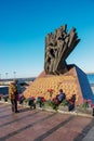 Monument to veterans of the Afghan war 1979-1989. Red carnations on the granite slab of the monument. People honor the memory of