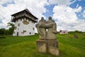 Monument to victims of motherland defending wars in a yard of ruined castle with ancient kozak tower, tourist sightseeing Royalty Free Stock Photo