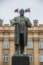 Monument to Vladimir Lenin on the square against building.