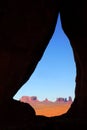 Monument Valley seen through Teardrop Arch Royalty Free Stock Photo