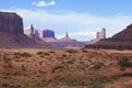 The Monument Valley in Utah Arizona state with the red earth desert in the foreground - USA Royalty Free Stock Photo