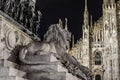 Monument of Victor Emanuelle II with Lion Statue in Milan, Italy, and Duomo Milan Cathedral in Background at Night. Royalty Free Stock Photo