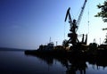 Monumental cranes at sunset.a ship in port