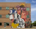 Monumental mural by artist Haylee Ryan Yale on a medical office building at Valoris Health Park in Garland, Texas.