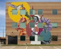 Monumental mural by artist Haylee Ryan Yale on a medical office building at Valoris Health Park in Garland, Texas.