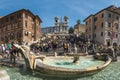 The monumental stairway Spanish Steps with TrinitÃÂ  dei Monti church at the top. Tourists at Piazza di Spagna near the fountain Royalty Free Stock Photo