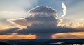 Monumental thunderhead cloud over a golden valley Royalty Free Stock Photo