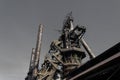 Monumental view of old steel mill with descending stairway, smokestacks