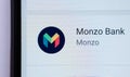 Monzo bank card on top of smartphone. Macro photo