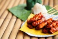 `Moo ping` grilled pork Thailand style Served with sticky rice on banana leaf