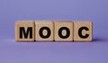 MOOC - acronym on wooden cubes on a lilac background