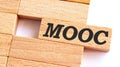 MOOC - Massive Open Online Course - handwriting on wooden block, business concept